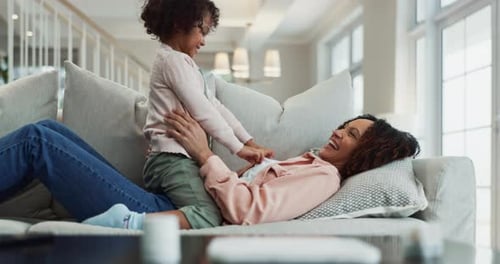 Mother and Child Playing Together on Couch