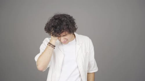 Young Adult Man Experiencing Headache and Stress