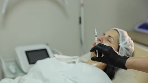 Beautician Performing Lip Augmentation Procedure with Filler Injection