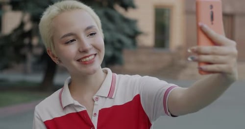 Smiling Woman Records Selfie Video Outdoors