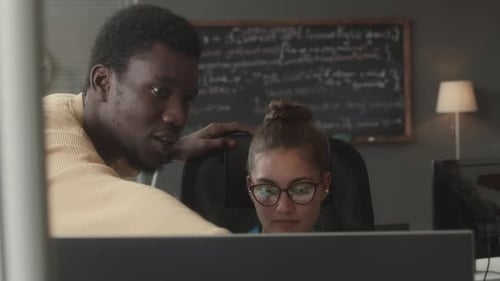 Programmer and IT Project Manager Having Talk in Office