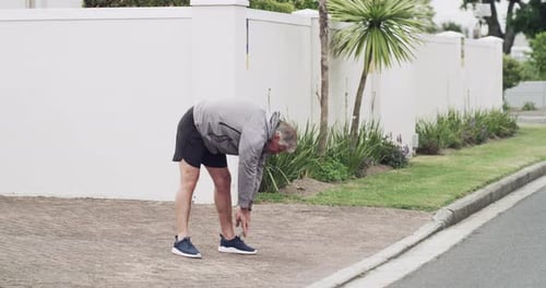 Senior Man Jogging in a Suburban Neighborhood