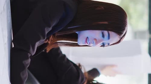 Vertical Video Designer Speaks to Advisor on Projected Hologram in Office Area