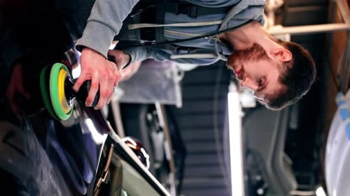 Vertical Video the Car Mechanic at a Service Station Doing the Final Polishing to Shine