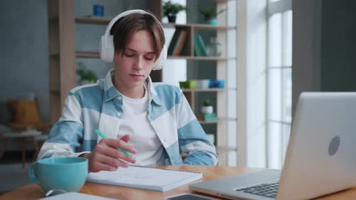 Teen Student Studying at Home with Laptop