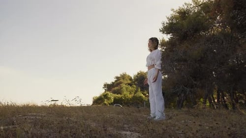 Woman Stretching Outdoors in a Natural Setting
