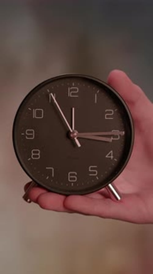Stylish and Elegant Clock Held in Hand A Concept for Effective Time Management