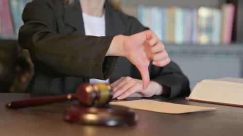 Close Up of Thumbs Down by Female Judge in Court, Scale on Justice