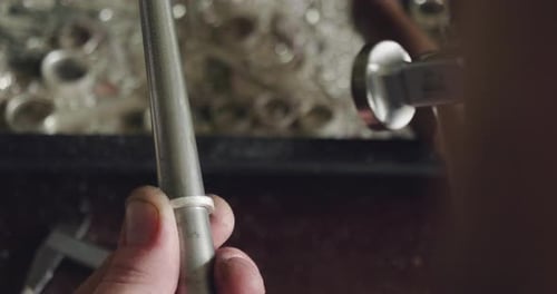 Close up of a goldsmith working the steel to make a ring. Concept: Diamond, silver, gold
