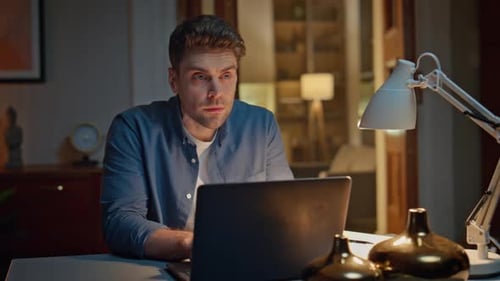 Man Working Late at Home on Laptop