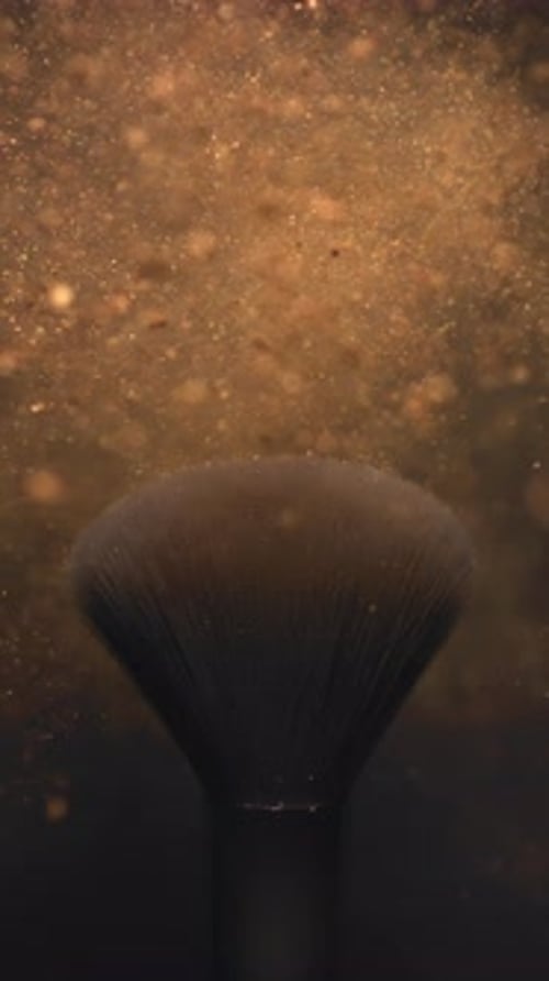 Golden Face Powder Explosion at 1000 Fps Makeup Brush and Elegant Luxury Cosmetic in Macro Abstract