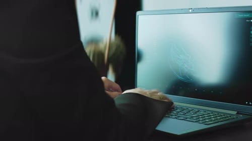 Person Typing Data Into a Laptop