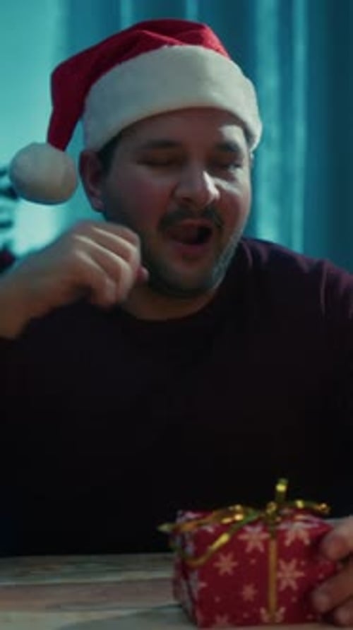 Young Man Falls Asleep On The Table Wrapping Christmas Presents In His Room