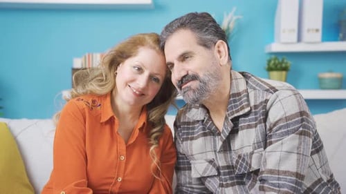 Loving Couple Smiling Together on a Sofa