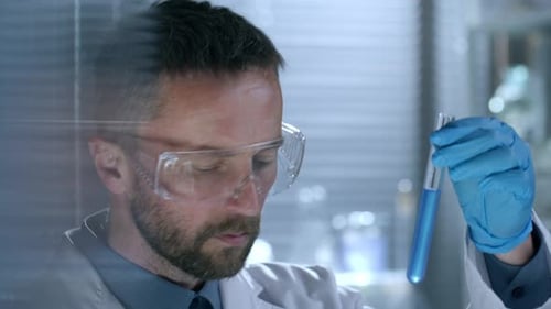 Scientist Examining Test Tube in Bright Laboratory
