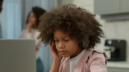 Young Child Using Laptop with Headphones