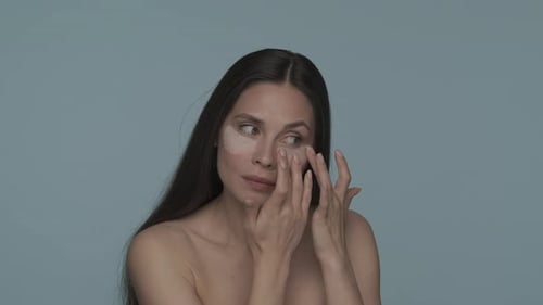Woman Applying Beauty Eye Patches