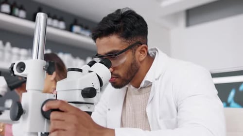 Scientist Using Microscope in Bright Lab Setting