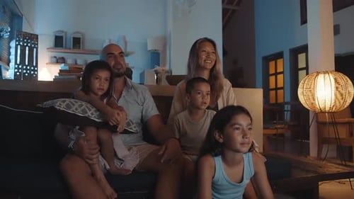Family Watching Television Together at Night