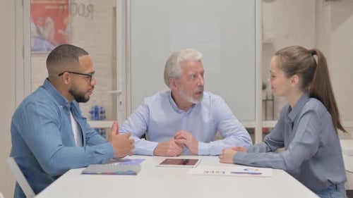 Mixed Race Business People Discussing Work in Office