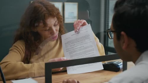 Unrecognizable Male Bank Assistant Listening to Female Customer in Office