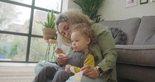 Woman and Child Playing with Confetti at Home