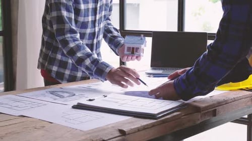 Architects and engineers brainstorm, plan the design of construction projects