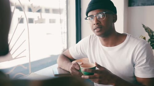 Friends, conversation and men talking in coffee shop for bonding, discussion and chatting together