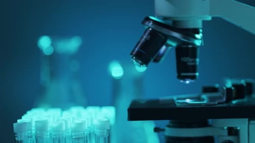 Microscope in a Laboratory with Test Tubes