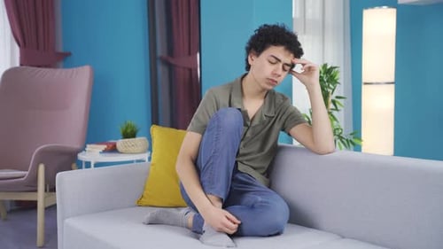 Sad and unhappy adolescent boy.