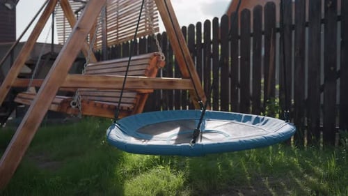 Rustic Wooden Swing Set in a Green Backyard