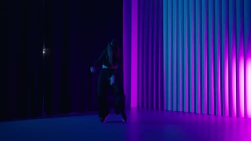 Beautiful Young Female Dancer Rehearsing In Studio With Neon Lights FullLength Portrait