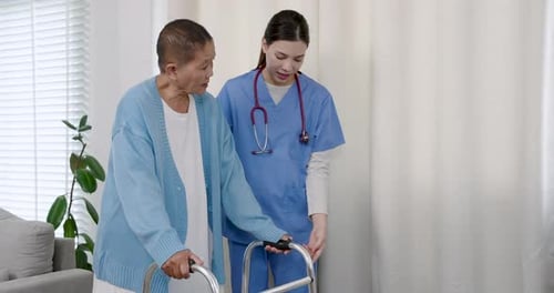 Woman Helping Senior with Walker in Home