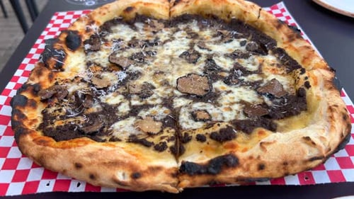 Delicious Truffle Pizza Close-Up on Red and White Checkered Paper