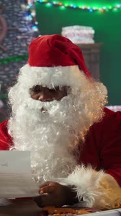 Vertical Video Father Christmas Reading Letters By the Fire in His Rustic Log Cabin