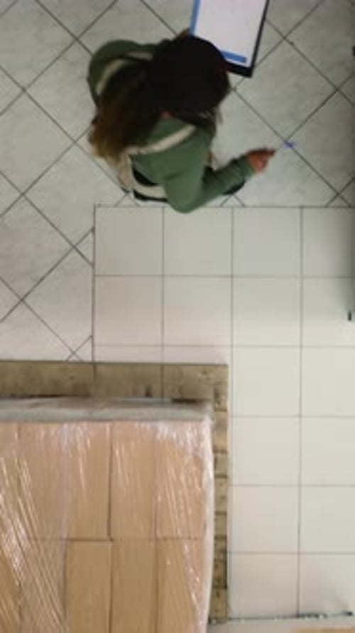 Vertical Video Warehouse Inspector Examines Parcels