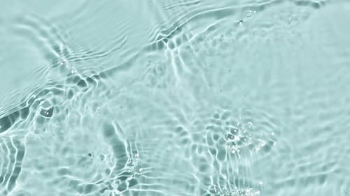 Pure Water with Reflections Sunlight in Slow Motion Water Surface Texture Top View Sun and Shadows