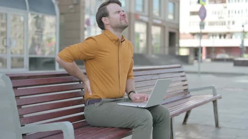 Man Using Laptop Computer has Back Pain