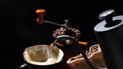 Pouring hot water to roasted coffee beans to make a coffee, drip coffee, pour over coffee.
