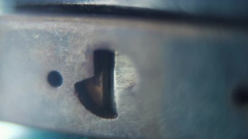 video of a padlock, shiny steel lock close up, security gear, slow motion 120fps, full HD, zoom out