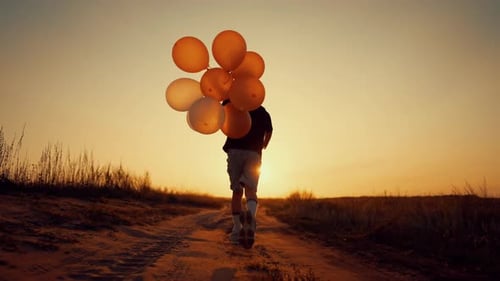Child Runs with Balloons on Rural Road at Sunset