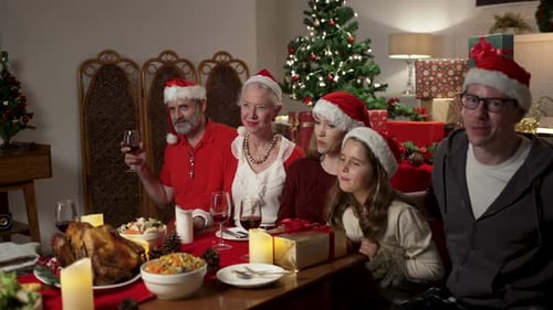 Family Celebrates Christmas Holiday at Home With Feast