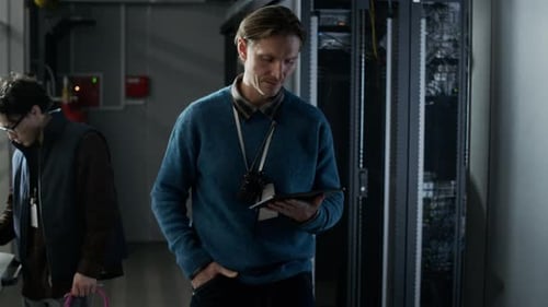 Technicians Inspecting Server Racks in Data Center