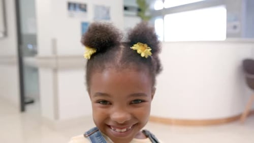 Portrait of happy african american girl in hospital, slow motion