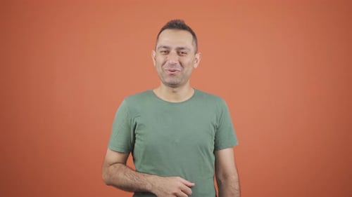 Smiling Man Waving and Blowing Kiss in Studio