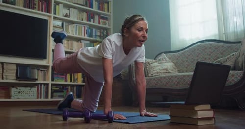 Woman Doing Online Exercise Class at Home