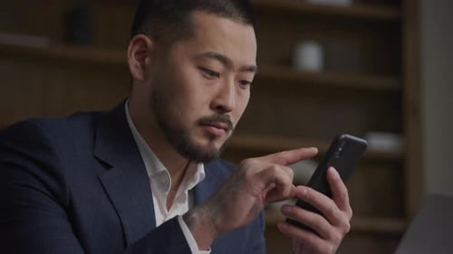 Businessman Reading on Smartphone Stock Market News