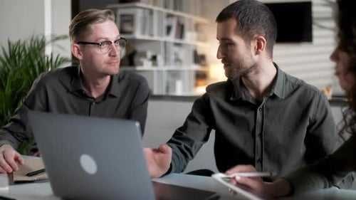 Colleagues And Clients Talking Strategy With Laptop And Tablet In Creative Office Productive