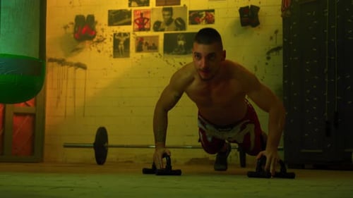 Muscular Man Doing Push Ups in Gym