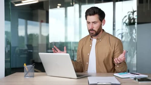 Man Having Online Meeting at Desk